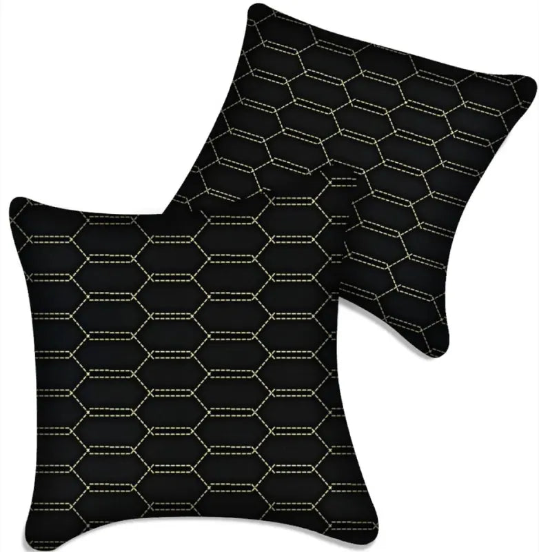 Black leather vehicle pillows with gold stitching